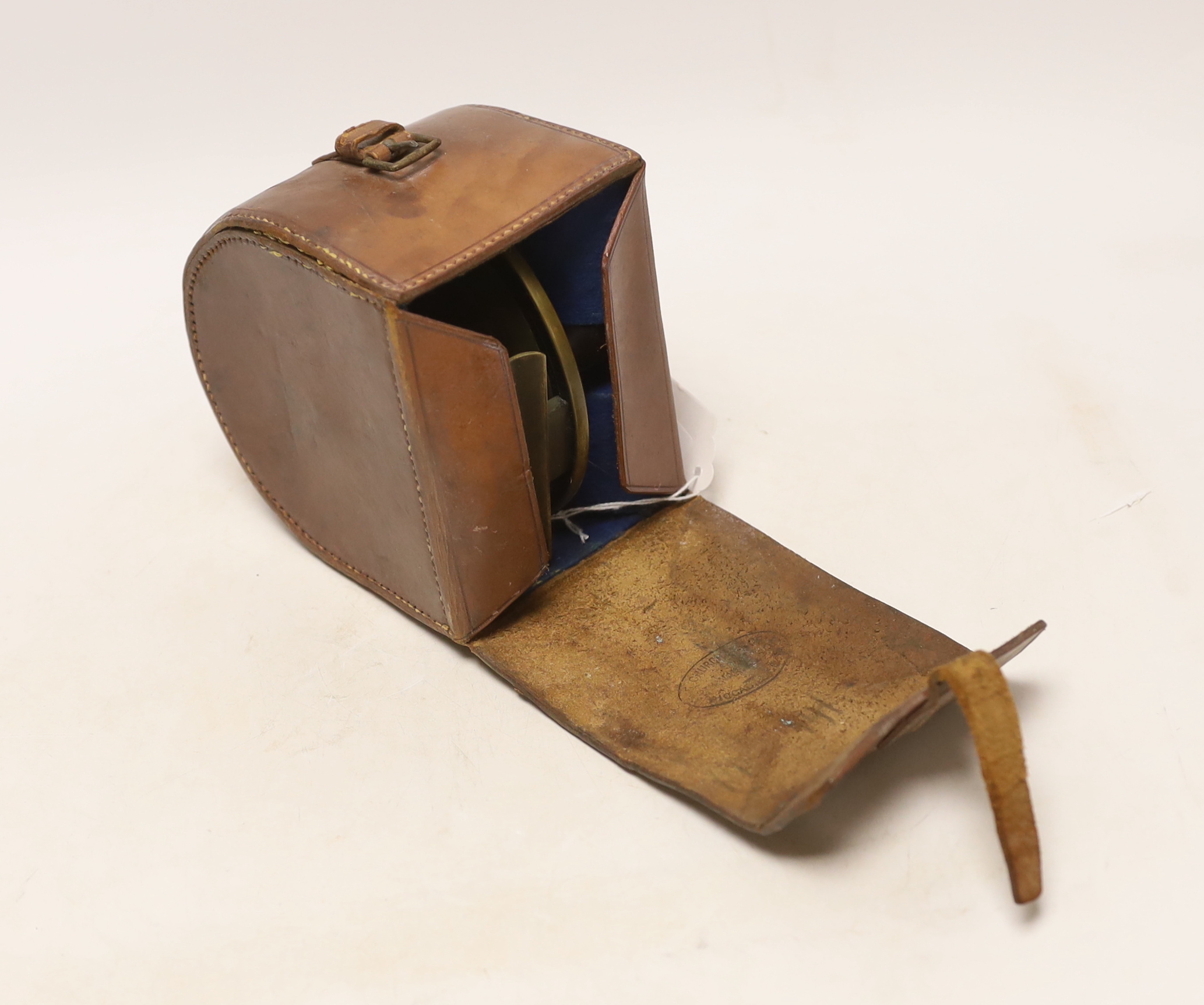 A large Bernard & Sons leather cased fishing reel